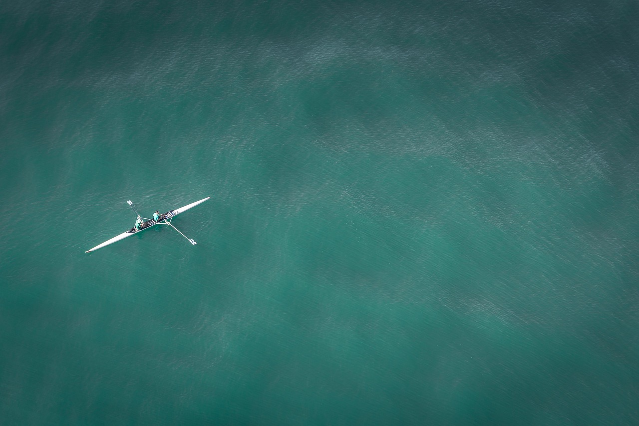 Professional rowing scull on calm water, aerial view